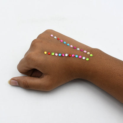 Self adhesive shining stones used to personalize a mobile cover and craft card.